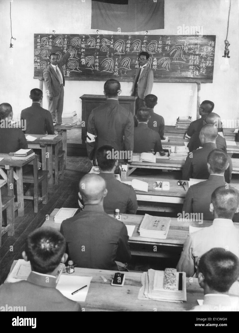 Japanese in Manchukuo create a new 100,000 police force in 60 days. Japanese instructors from Tokyo drill peasants in reading Stock Photo
