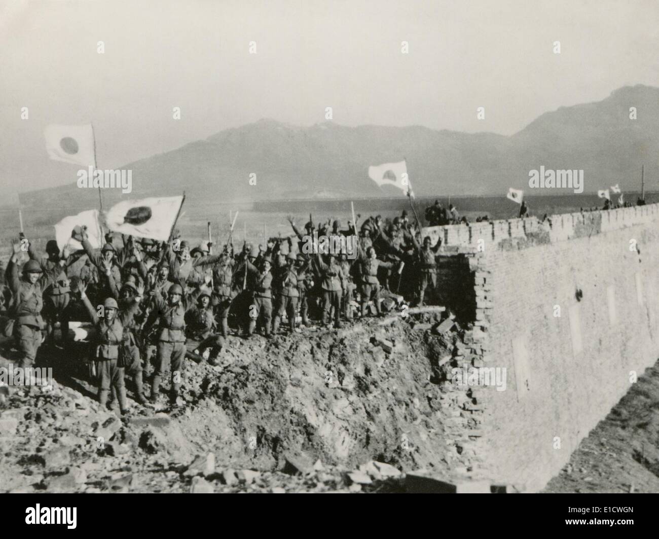 Japanese soldiers celebrate the capture of Nanking, China. A detachment of Japanese troops on the high wall of Nanking give a Stock Photo