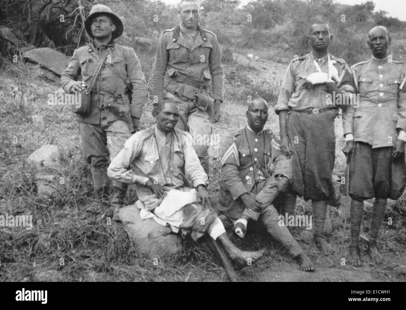 Two Italian soldiers with four wounded barefoot Ethiopian POWs. Italo-Ethiopian War, 1935-36. (BSLOC 2014 7 34) Stock Photo