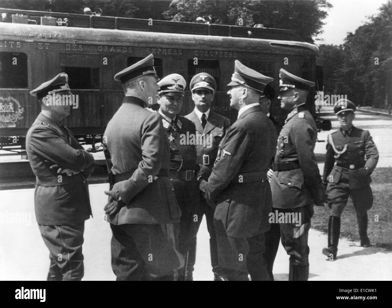 Adolf Hitler in Compiegne, France. He speaks with German generals in front of same train carriage in which the 1918 World War 1 Stock Photo