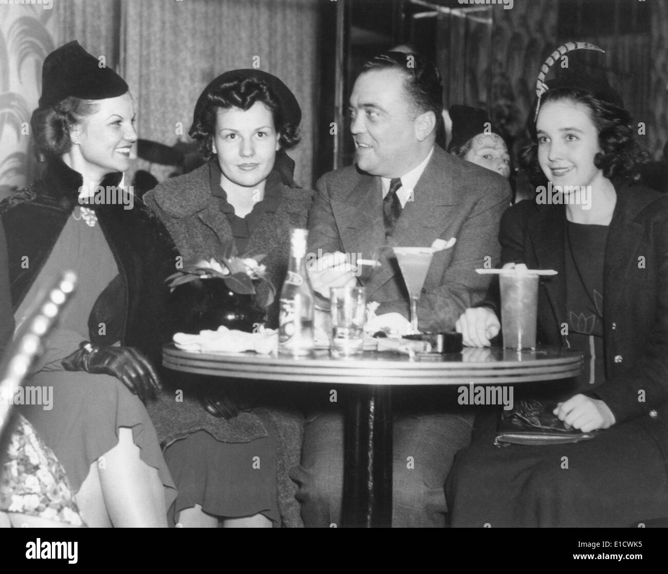 FBI Director J. Edgar Hoover at the Stork Club with three young women. At right is 1930's supermodel, Marion Morehouse. Ca. Stock Photo