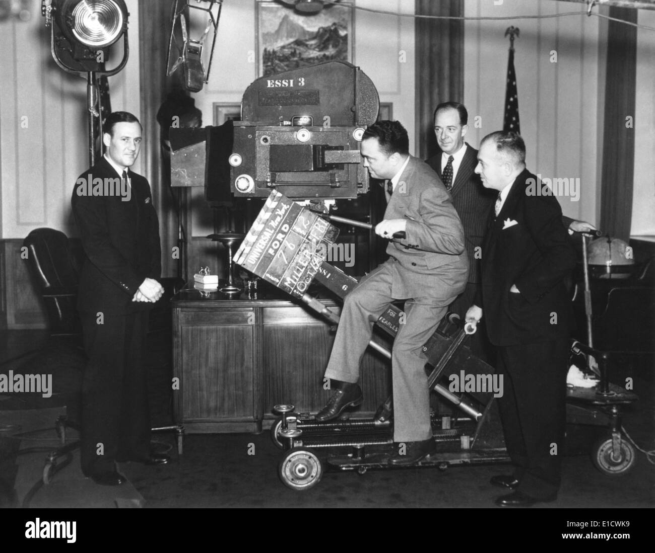 FBI Director J. Edgar Hoover with a Newsreel camera at Universal Studios.  Clyde Tolson, Hoover's FBI colleague and personal Stock Photo