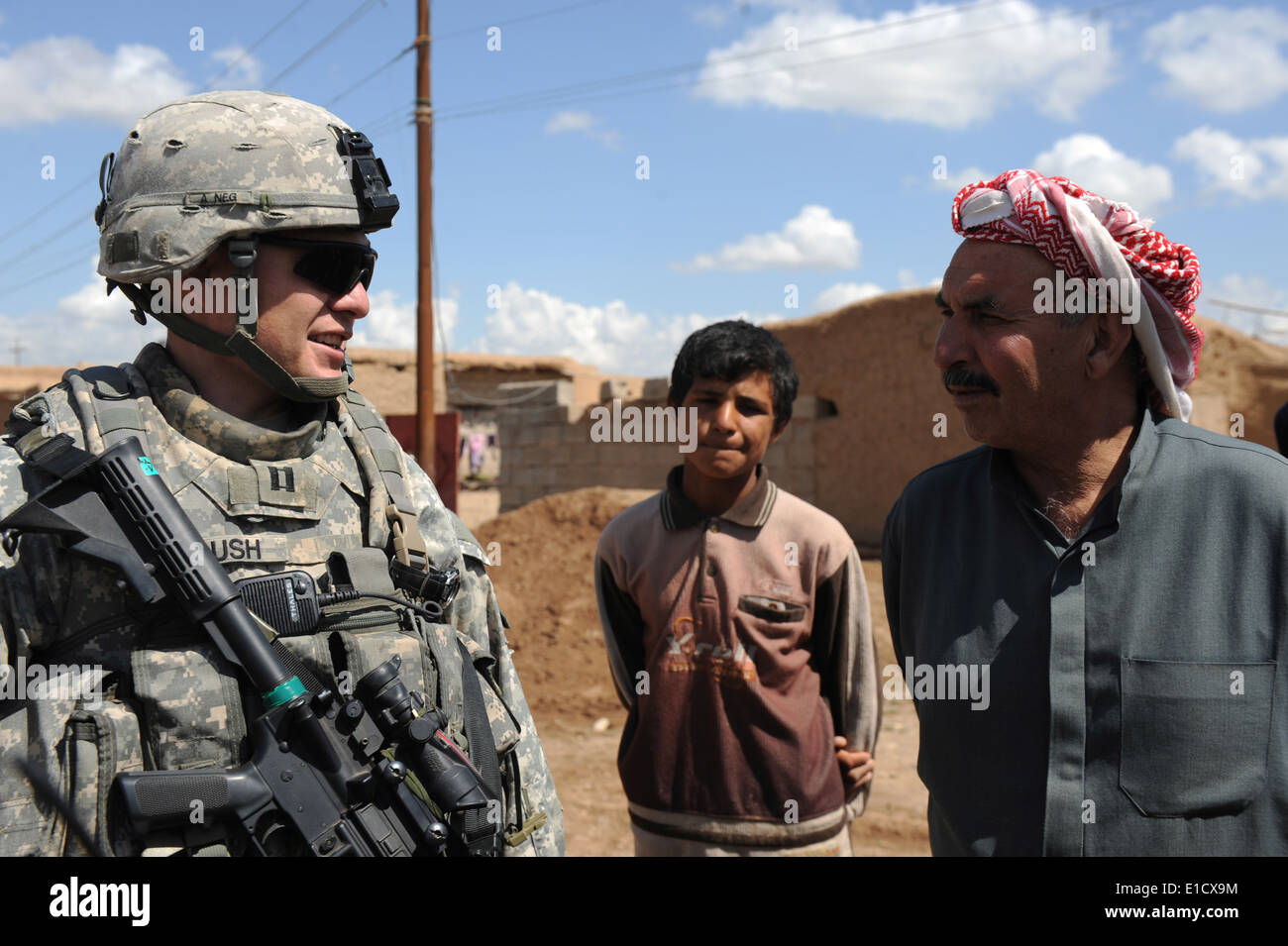 U.S. Army Capt. Charles Roush speaks with a village muktar in Yurimjah, Iraq, March 31, 2010, about the possibility of establis Stock Photo