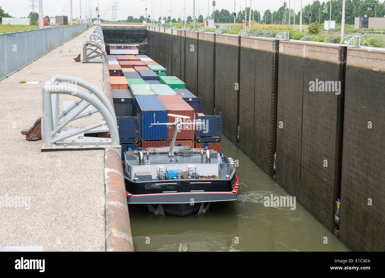 cargo ship in the maas river lock in holland Stock Photo