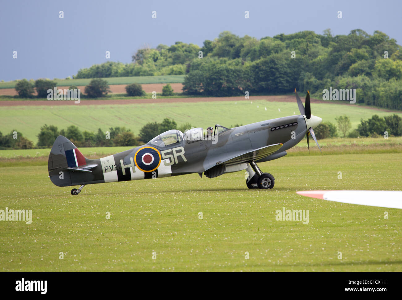 A World War II Spitfire fighter at Duxford Air Show in D-Day markings ...