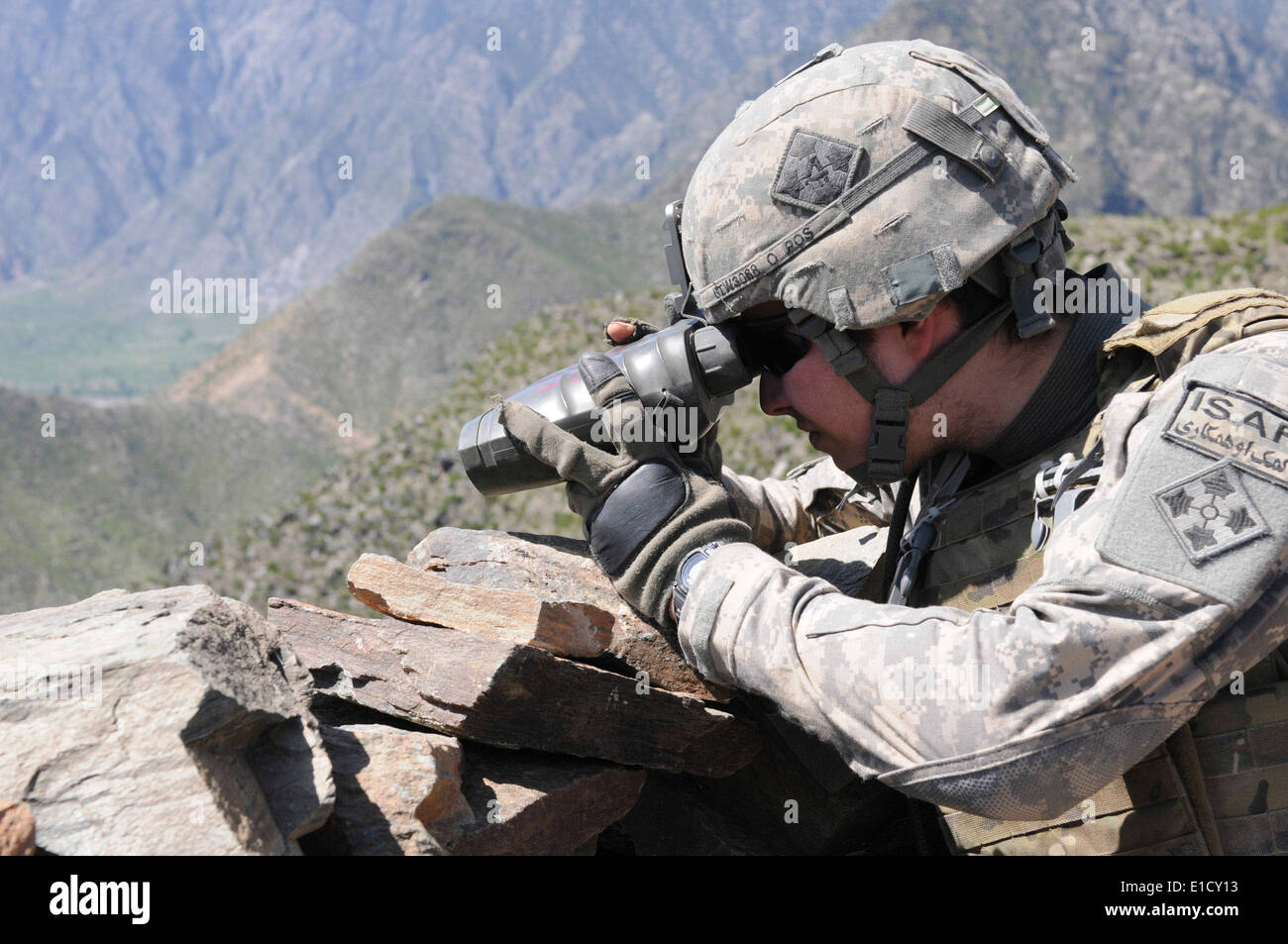 U.S. Army Pvt. Michael S. Walters monitors an Afghan National Army visit to Nishigam village in the eastern Kunar province of A Stock Photo