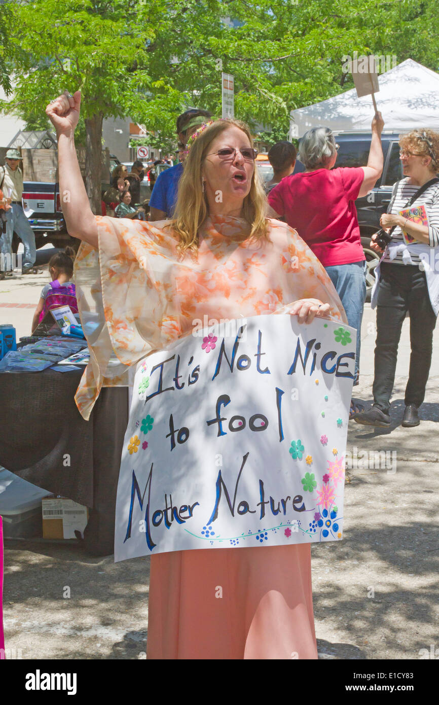 Asheville North Carolina USA - May 24 2014: A woman holds a flowery sign saying 'It's Not Nice to Fool Mother Nature in downtown Stock Photo