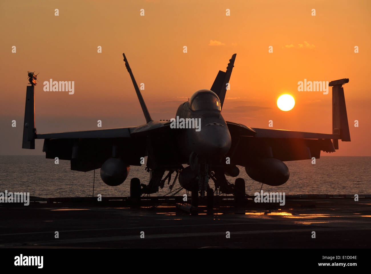 A U.S. Navy F/A-18E Super Hornet aircraft assigned to the ?Tophatters? of Strike Fighter Squadron 14 is shown tied-down on the Stock Photo
