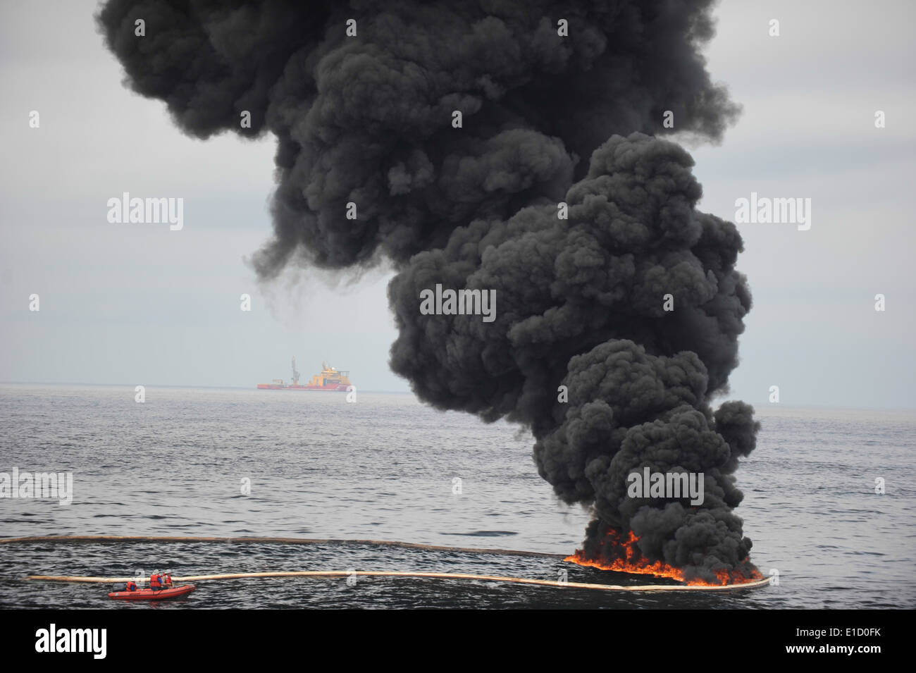 Gathered concentrated oil burns during a controlled oil fire May 5, 2010, in the Gulf of Mexico off the coast of Venice, La. Th Stock Photo