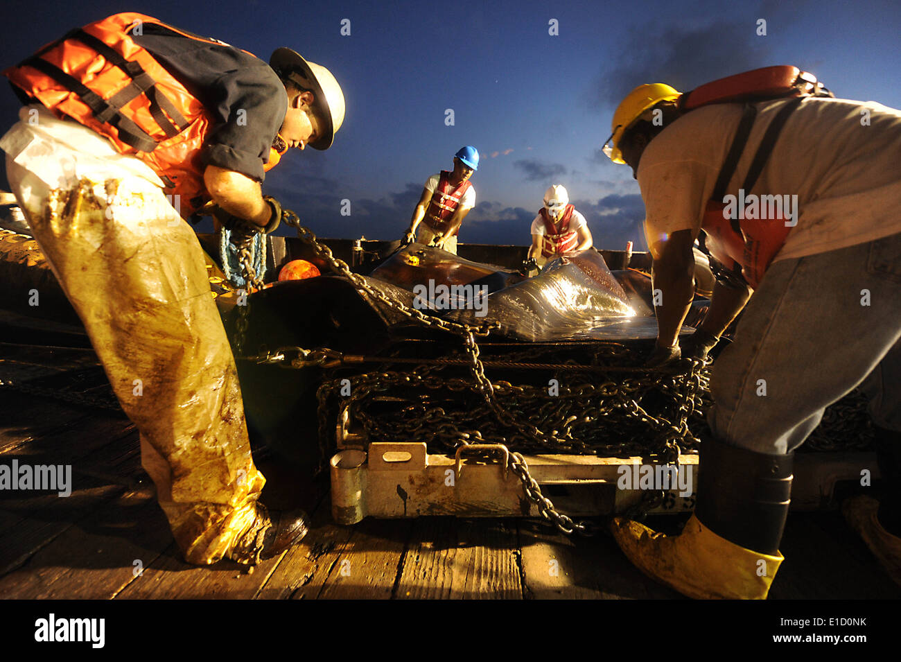 Crewmembers from Marine Vessel Braxton Perry recover a deflection boom in the Gulf of Mexico May 7, 2010, after three days of c Stock Photo