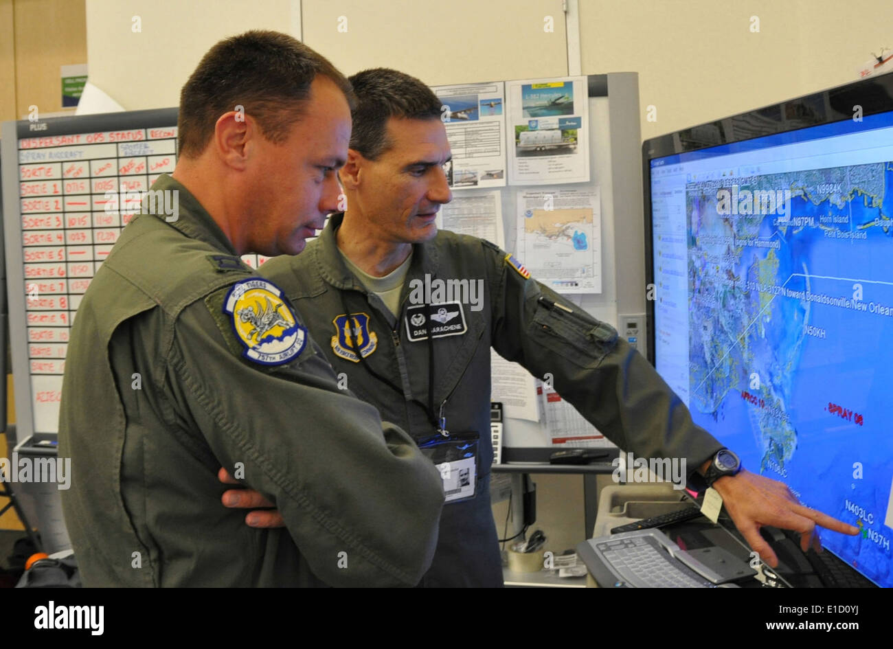 HOUMA, LA -- Air Force Reserve Lt. Col. Dan Sarachene (rear) reviews a map of the Gulf of Mexico with Capt. Travis Adams at the Stock Photo