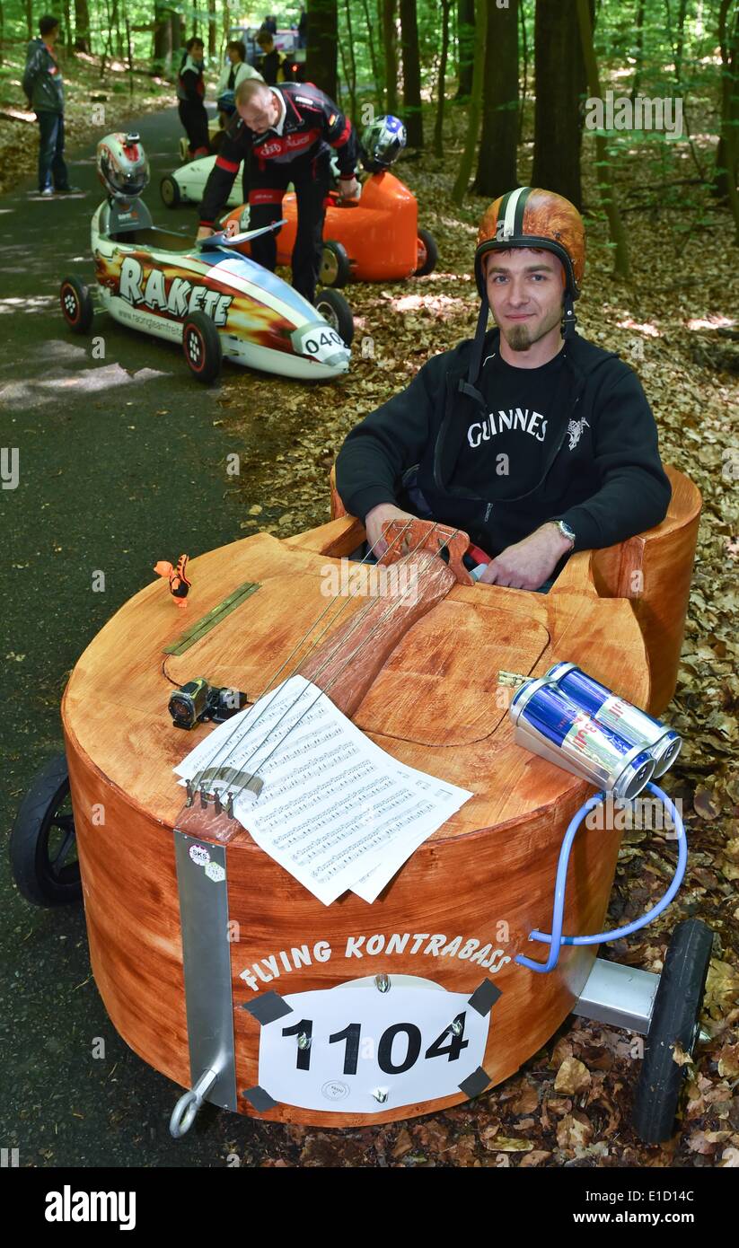 Rauen, Germany. 31st May, 2014. Lars Krueger sits in his double bass-shaped soapbox during the soapbox car race in Rauen, Germany, 31 May 2014. More than fifty participants take part in the gravity racer race. Photo: Patrick Pleul/dpa/Alamy Live News Stock Photo
