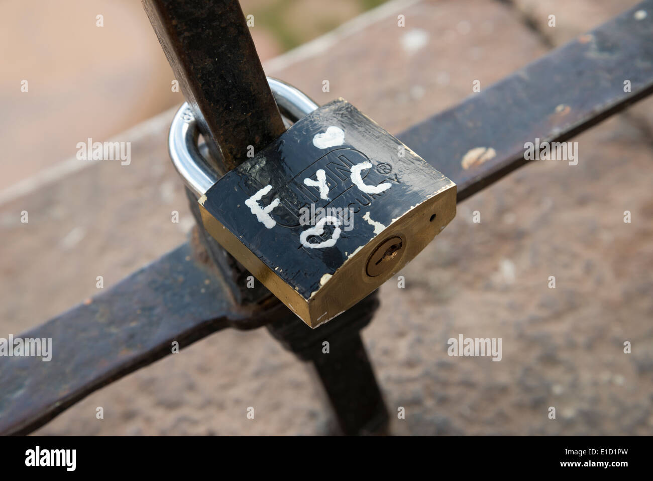 Padlock locked on railings, to represent two people's everlasting love for each other. Stock Photo