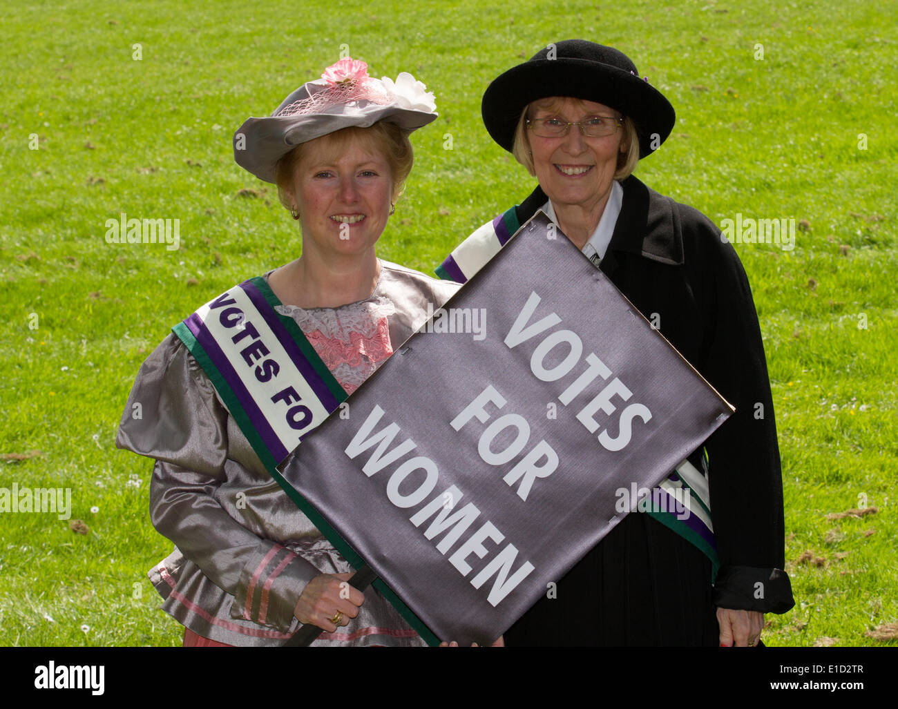Votes for women suffrage, a woman seeking the right to vote through organized protest. Suffragettes fancy dress 1903 period outfits for adults with placards in Preston, UK 31st May, 2014. Goosnargh & Whittingham Whitsuntide Festival. This wonderful piece of English Heritage, which took place on a gloriously sunny Saturday, is organised by the Festival Committee and a group of hugely dedicated friends in Goosnargh & Whittingham, close to the city of Preston in Lancashire, North West England. Stock Photo
