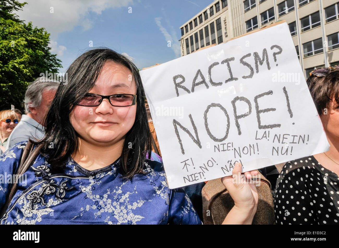 Belfast, Northern Ireland. 31 May 2014 - A woman holds a sign saying 'Racism? Nope!'. Thousands of people turn out for an anti-racism rally held in support of Anna Lo MLA.  Ms Lo had threatened to leave Northern Ireland because of the amount of racist attacks. Credit:  Stephen Barnes/Alamy Live News Stock Photo