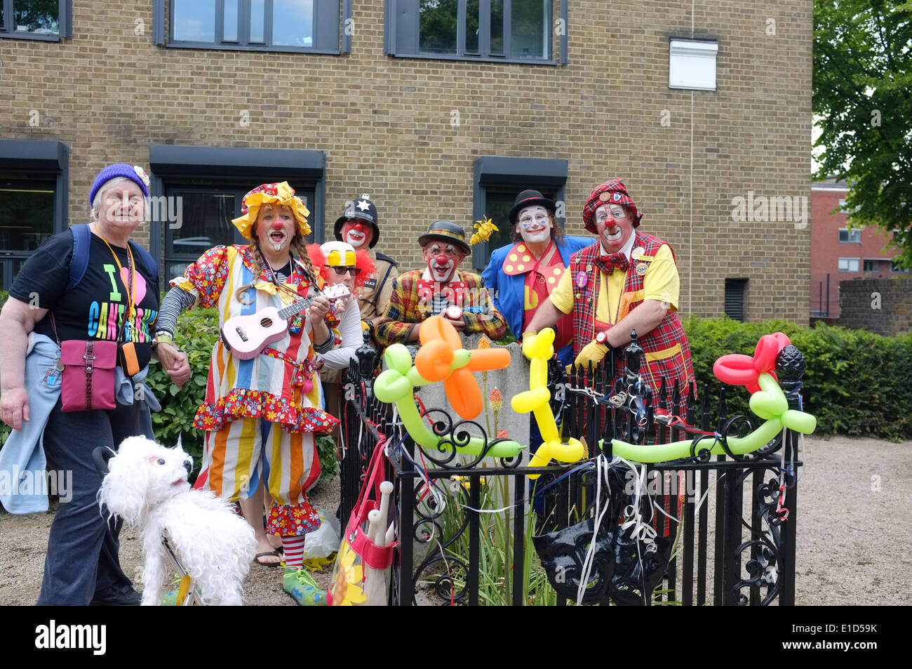 31st May 2014 : clowns celebrate 177 years since the death of Joseph Grimaldi (1778-1837) at his grave in Joseph Grimaldi Park in St. James's Churchyard Pentonville Road, London N1 UK. Stock Photo