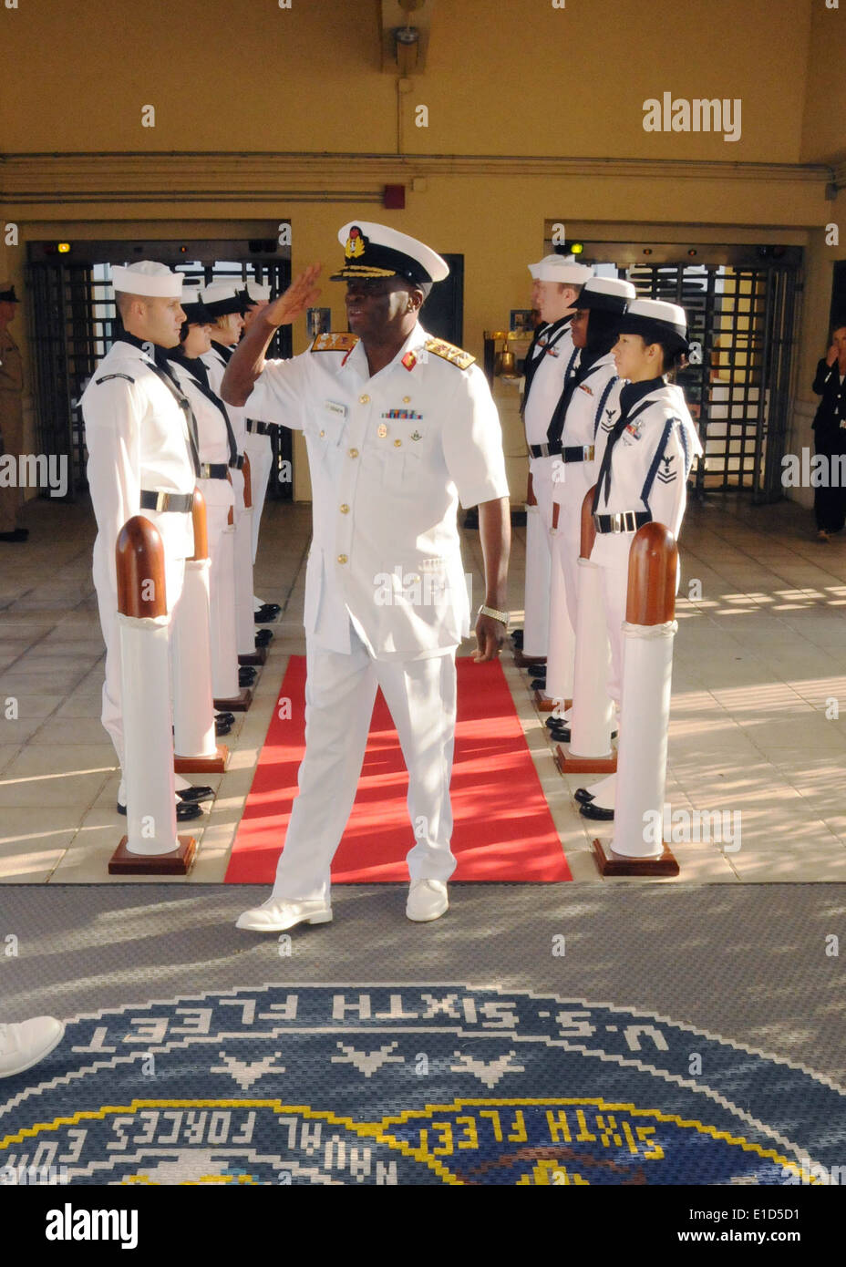 Nigerian Chief of Naval Staff Vice Adm. Ishaya Iko Ibrahim salutes while being greeted by U.S. Sailors assigned to U.S. Naval F Stock Photo