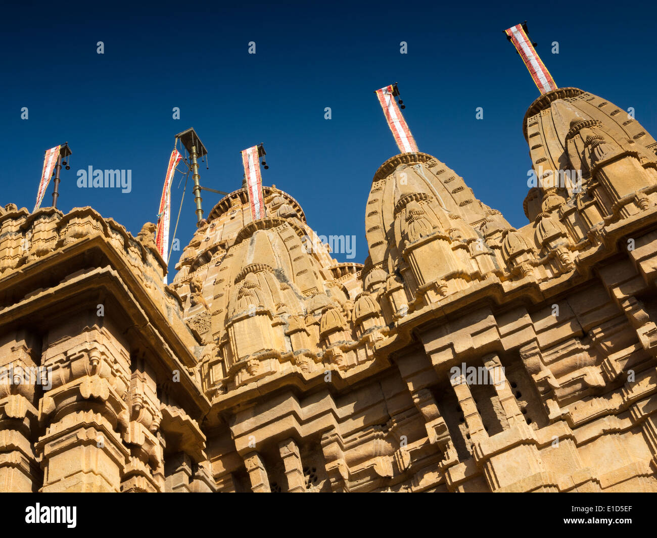 India, Rajasthan, Jaisalmer, Fort, Jain Temple architectural detail of towers against blue sky Stock Photo