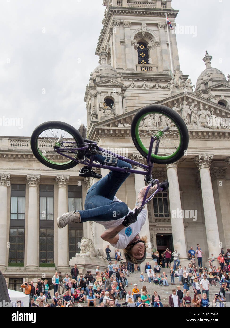 A BMX rider performs an aerial stunt in front of crowds gathered on the Portsmouth Guildhall steps, during the Portsmouth street games funded by the Portsmouth cultural trust Stock Photo