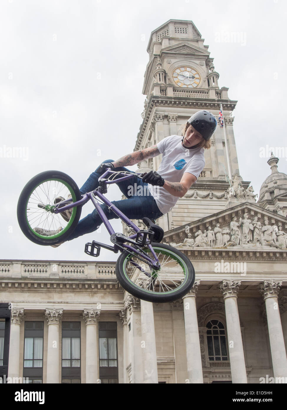 A BMX rider performs an aerial stunt in front of the Portsmouth Guildhall, during the Portsmouth street 2014 games funded by the Portsmouth cultural trust. Stock Photo