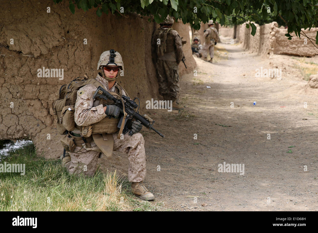 US Marines with the 1st Battalion, 7th Marine Regiment, patrol during a counter-insurgency mission May 16, 2014 in Larr Village, Helmand province, Afghanistan. Stock Photo