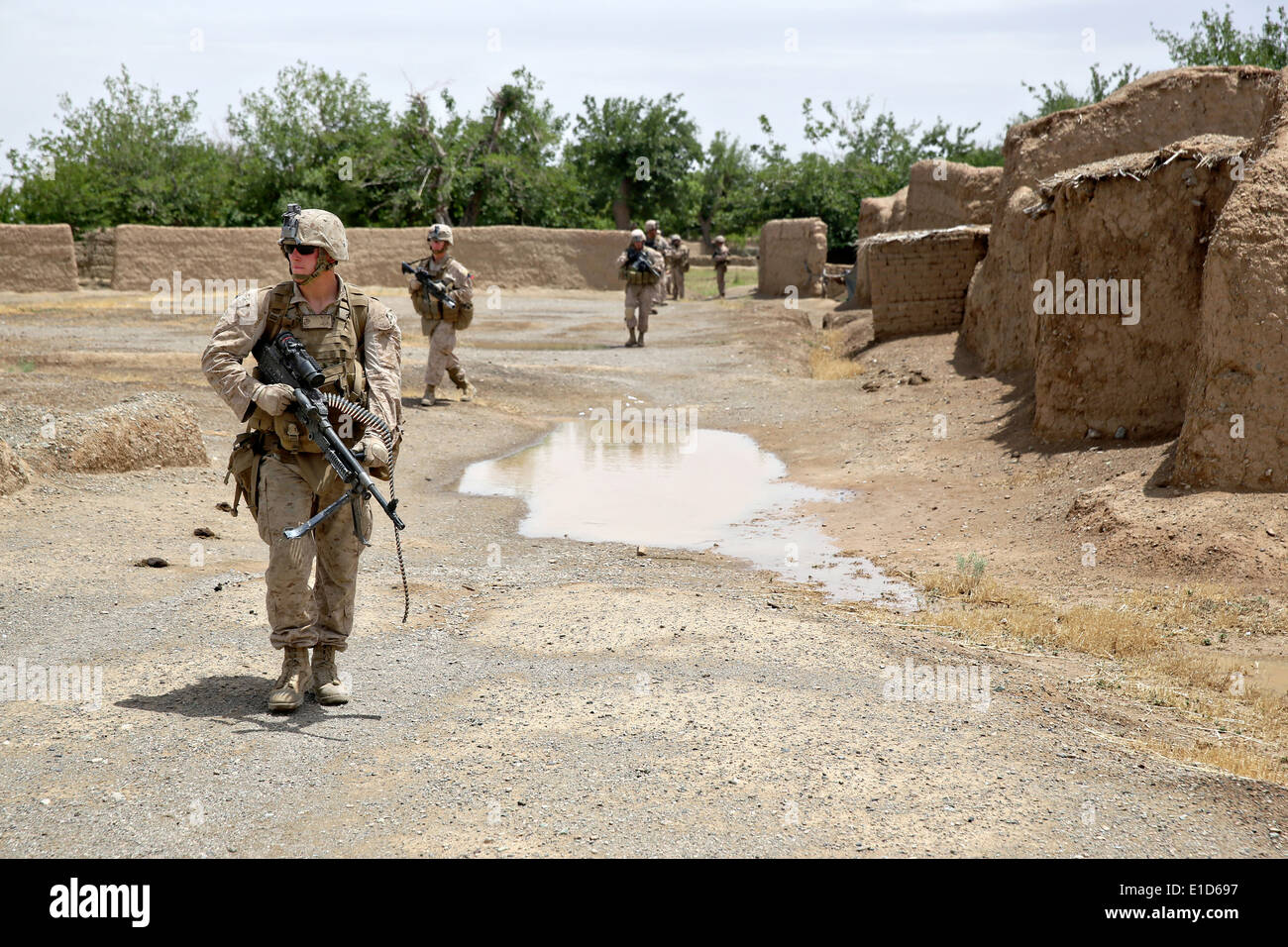 US Marines with the 1st Battalion, 7th Marine Regiment, patrol during a a counter-insurgency mission May 16, 2014 in Larr Village, Helmand province, Afghanistan. Stock Photo