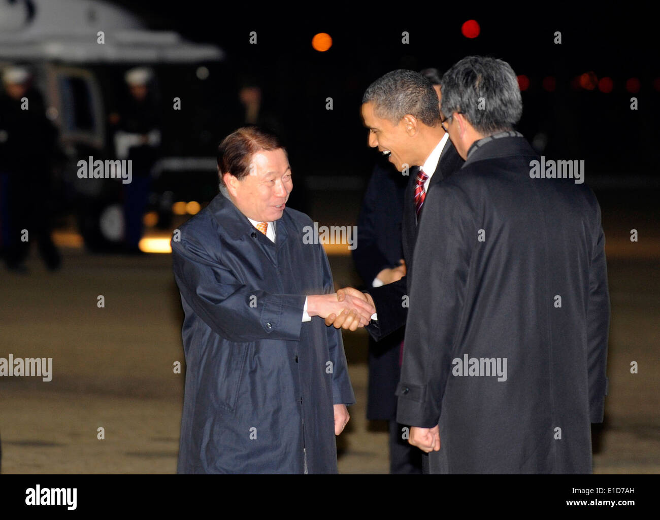 U.S. President Barack Obama shakes hands with Republic of Korea Foreign Minister Yu Myung-hwan after arriving at Osan Air Base, Stock Photo