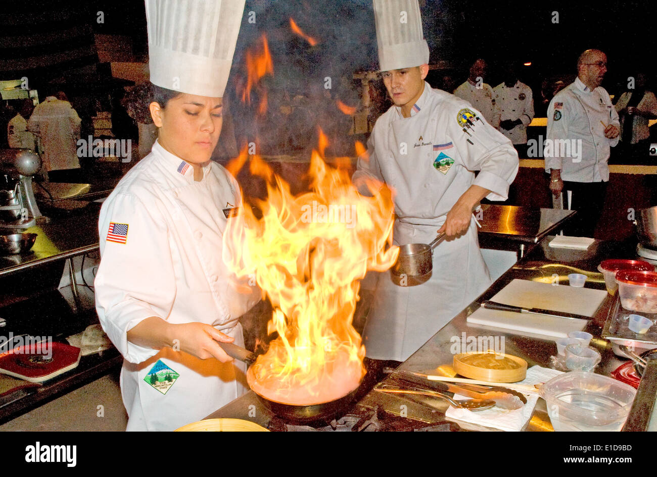 U.S. Army Pvt. Danielle Cassinacabrera and Cpl. Jason Daniels compete in the Junior Chef competition during the 35th Culinary A Stock Photo