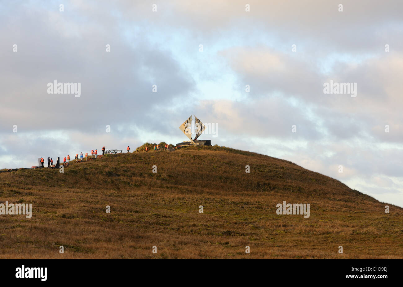 Tourists in orange life jackest visit the albatross memorial, Monumento Cabo de Hornos, to those lost  at sea. Cape Horn Nationa Stock Photo