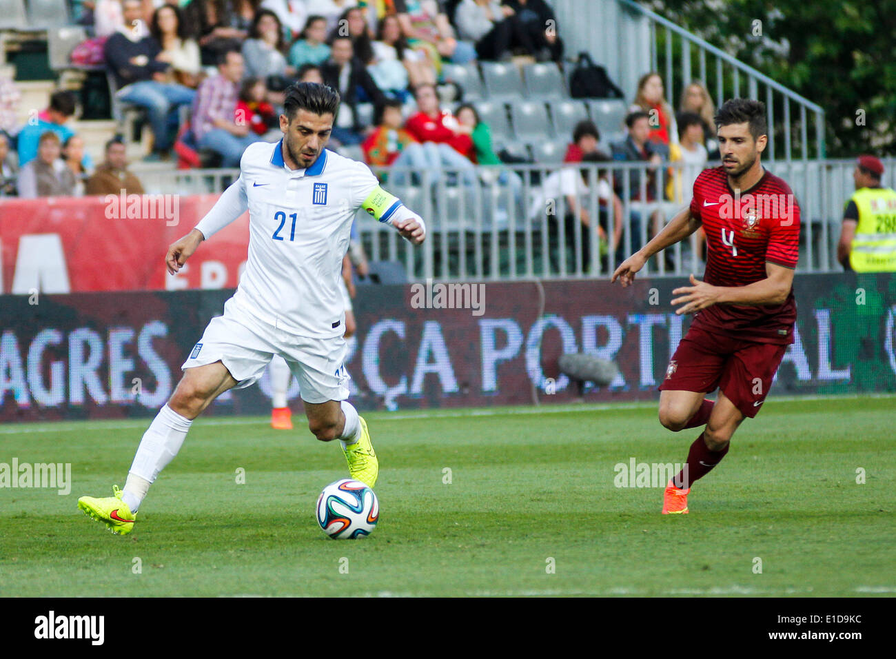 Lisbon, Porrtugal. 31st May, 2014. Greece midfielder Kostas Katsouranis (21) and Portugal midfielder Miguel Veloso (4) in action during preparatory friendly match for the World Cup at the National Stadium in Lisbon, Portugal, Saturday, May 31, 2014. Credit:  Leonardo Mota/Alamy Live News Stock Photo