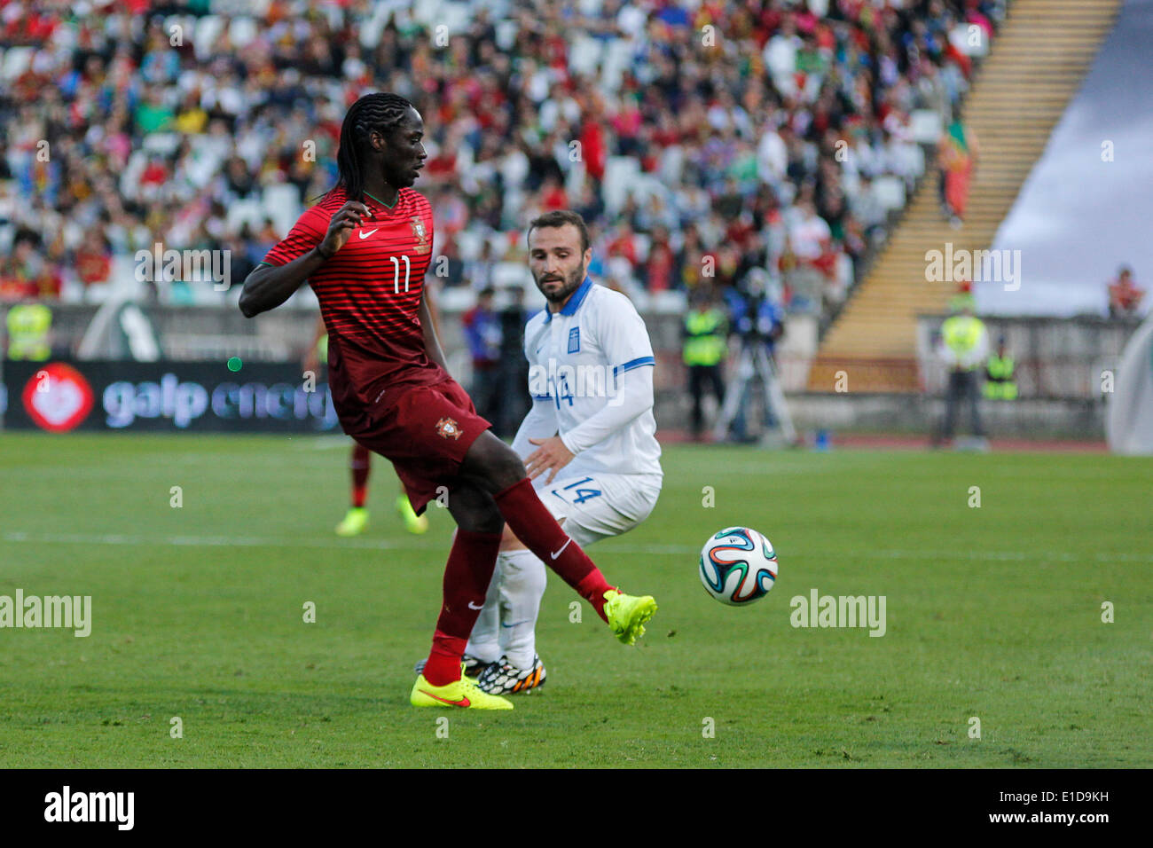 Lisbon, Porrtugal. 31st May, 2014. Portugal forward Eder (11) in action followed by Greece forward Dimitris Salpingidis (14) during preparatory friendly match for the World Cup at the National Stadium in Lisbon, Portugal, Saturday, May 31, 2014. Credit:  Leonardo Mota/Alamy Live News Stock Photo