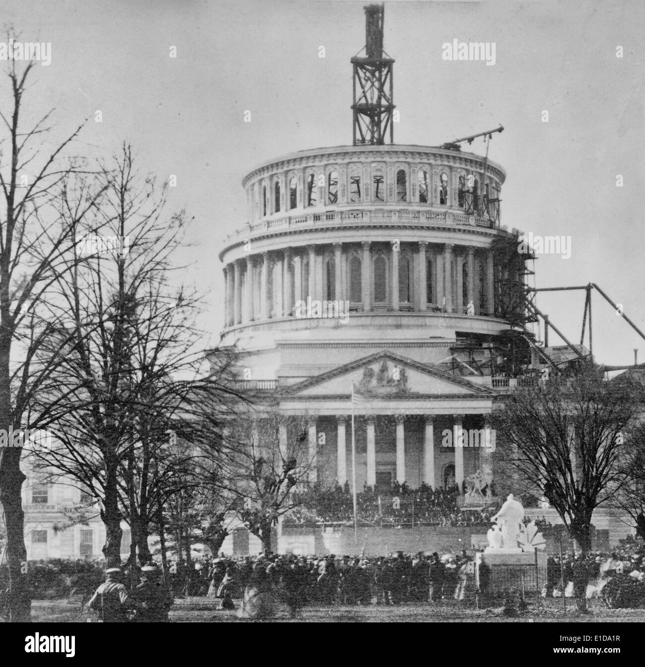 Inauguration of Abraham Lincoln at the U.S. Capitol, 1861.  Crowds of people viewing Abraham Lincoln's inauguration at the east front of the U.S. Capitol, with the Capitol dome under construction. Stock Photo