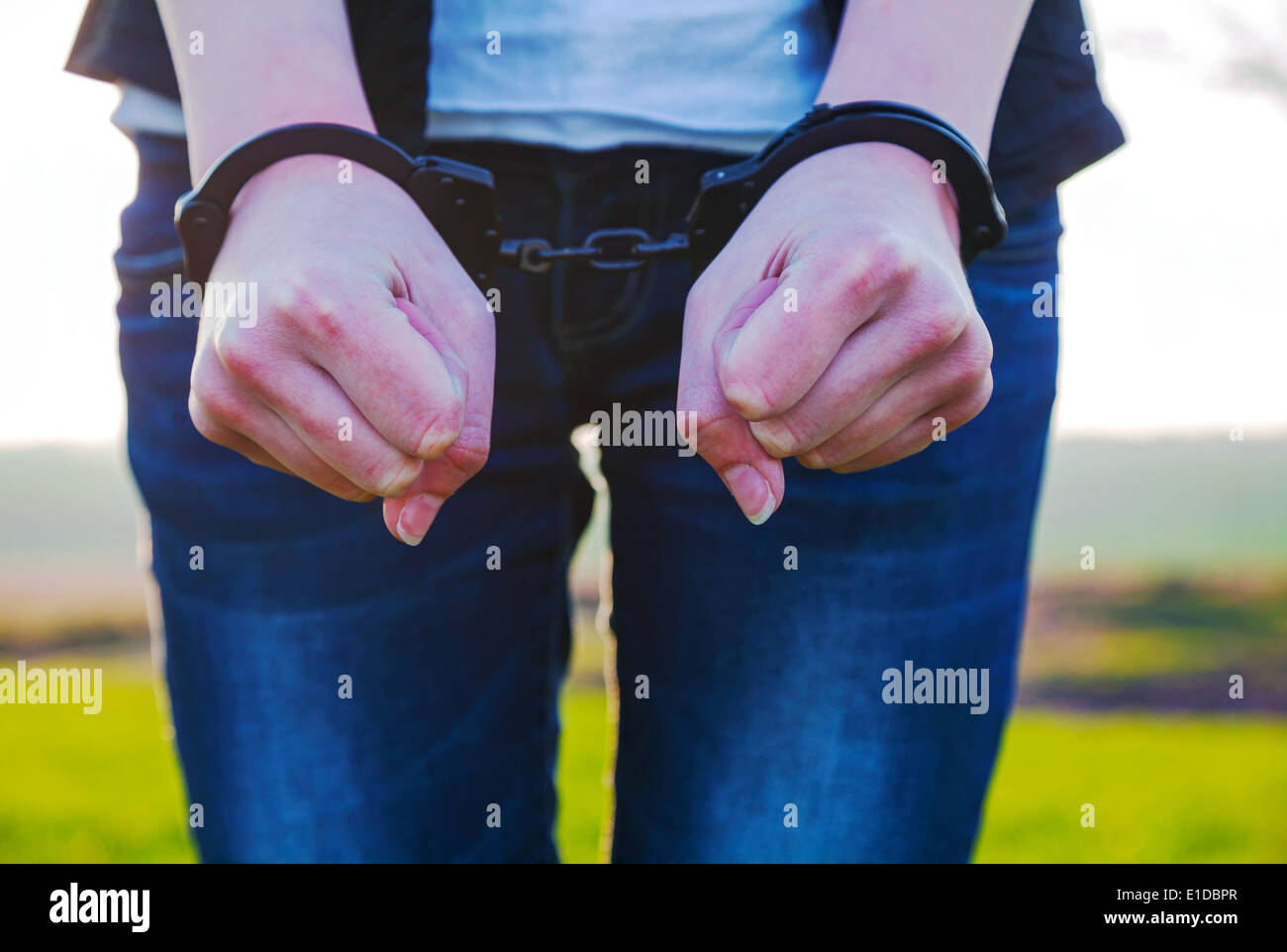 Handcuffed woman hands outdoors Stock Photo