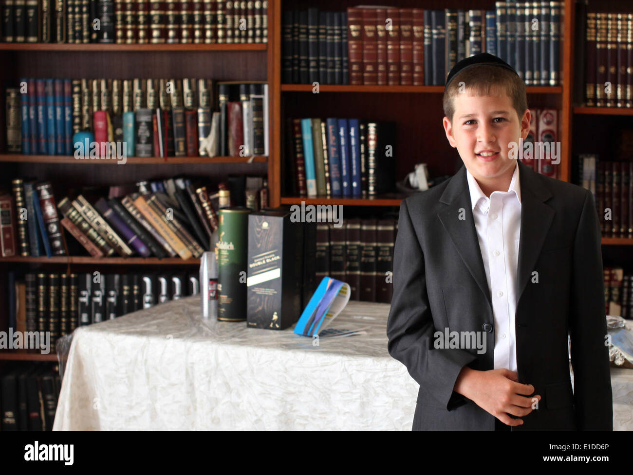 (140601) -- JERUSALEM, June 1, 2014 (Xinhua) -- Tzviel Noyman stands in front of book shelves at his home in Beit Shemesh, about 20 km from Jerusalem, on May 30, 2014. Tzviel Noyman is an Israeli Ultra-Orthodox boy in a family with six children, three boys and three girls. He is ten years old this year and a grade three pupil of Torat Moshe elementary school, which is only opened to Jewish children. Tzviel has eight classes each day, including Hebrew, English, mathematics and Jewish religion, which has four classes each day including Talmud, Mishnah and Gemara. Tzviel likes the religion class Stock Photo