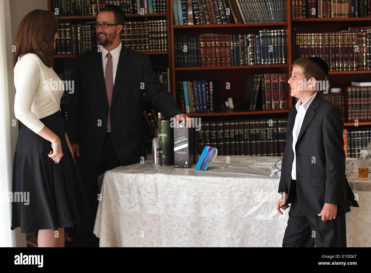 (140601) -- JERUSALEM, June 1, 2014 (Xinhua) -- Tzviel Noyman is seen with his parents at their home in Beit Shemesh, about 20 km from Jerusalem, on May 30, 2014. Tzviel Noyman is an Israeli Ultra-Orthodox boy in a family with six children, three boys and three girls. He is ten years old this year and a grade three pupil of Torat Moshe elementary school, which is only opened to Jewish children. Tzviel has eight classes each day, including Hebrew, English, mathematics and Jewish religion, which has four classes each day including Talmud, Mishnah and Gemara. Tzviel likes the religion class best Stock Photo