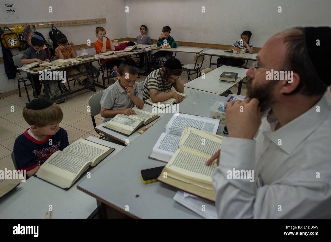 (140601) -- JERUSALEM, June 1, 2014 (Xinhua) -- Orthodox Jewish pupils take a class of Jewish religion at Torat Moshe elementary school in Beit Shemesh, about 20 km from Jerusalem, on May 29, 2014. Tzviel Noyman is an Israeli Ultra-Orthodox boy in a family with six children, three boys and three girls. He is ten years old this year and a grade three pupil of Torat Moshe elementary school, which is only opened to Jewish children. Tzviel has eight classes each day, including Hebrew, English, mathematics and Jewish religion, which has four classes each day including Talmud, Mishnah and Gemara. Tz Stock Photo