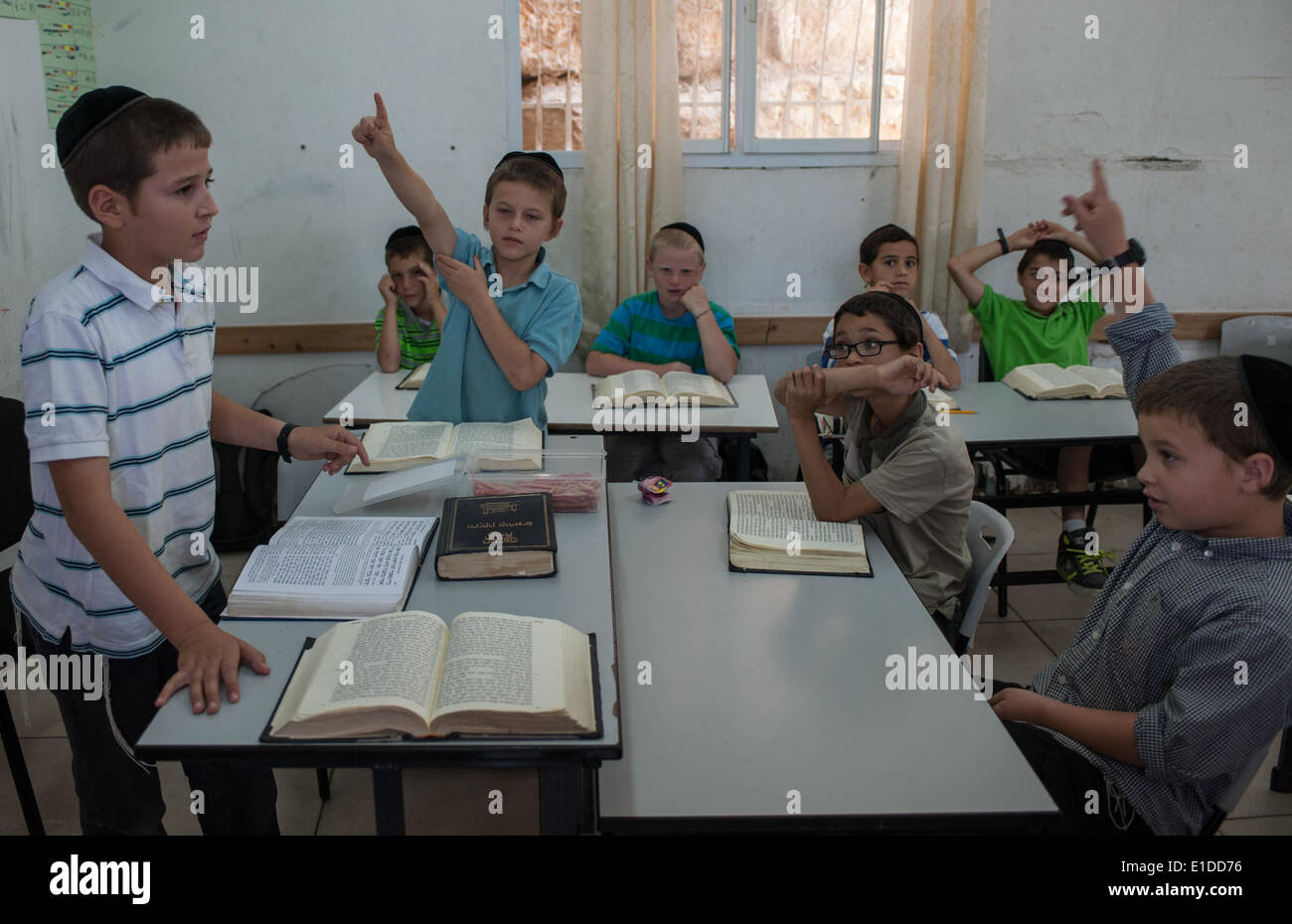 (140601) -- JERUSALEM, June 1, 2014 (Xinhua) -- Tzviel Noyman (1st L) asks a question when leading a class of Jewish religion at Torat Moshe elementary school in Beit Shemesh, about 20 km from Jerusalem, on May 29, 2014. Tzviel Noyman is an Israeli Ultra-Orthodox boy in a family with six children, three boys and three girls. He is ten years old this year and a grade three pupil of Torat Moshe elementary school, which is only opened to Jewish children. Tzviel has eight classes each day, including Hebrew, English, mathematics and Jewish religion, which has four classes each day including Talmud, Stock Photo