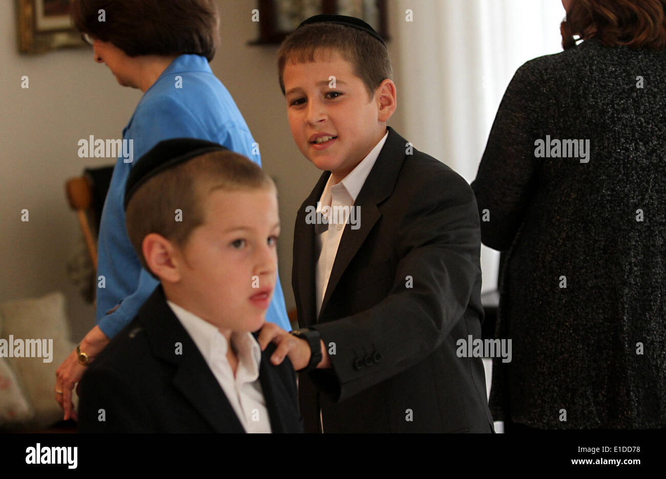 (140601) -- JERUSALEM, June 1, 2014 (Xinhua) -- Tzviel Noyman (C) is seen with his family at their home in Beit Shemesh, about 20 km from Jerusalem, on May 30, 2014. Tzviel Noyman is an Israeli Ultra-Orthodox boy in a family with six children, three boys and three girls. He is ten years old this year and a grade three pupil of Torat Moshe elementary school, which is only opened to Jewish children. Tzviel has eight classes each day, including Hebrew, English, mathematics and Jewish religion, which has four classes each day including Talmud, Mishnah and Gemara. Tzviel likes the religion class be Stock Photo