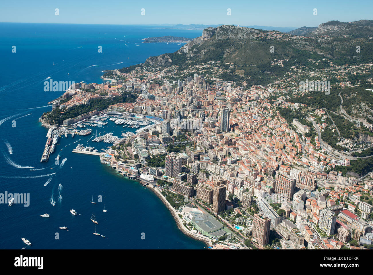 AERIAL VIEW. The Principality of Monaco between the Mediterranean shores and the southernmost tip of the Alps. Stock Photo