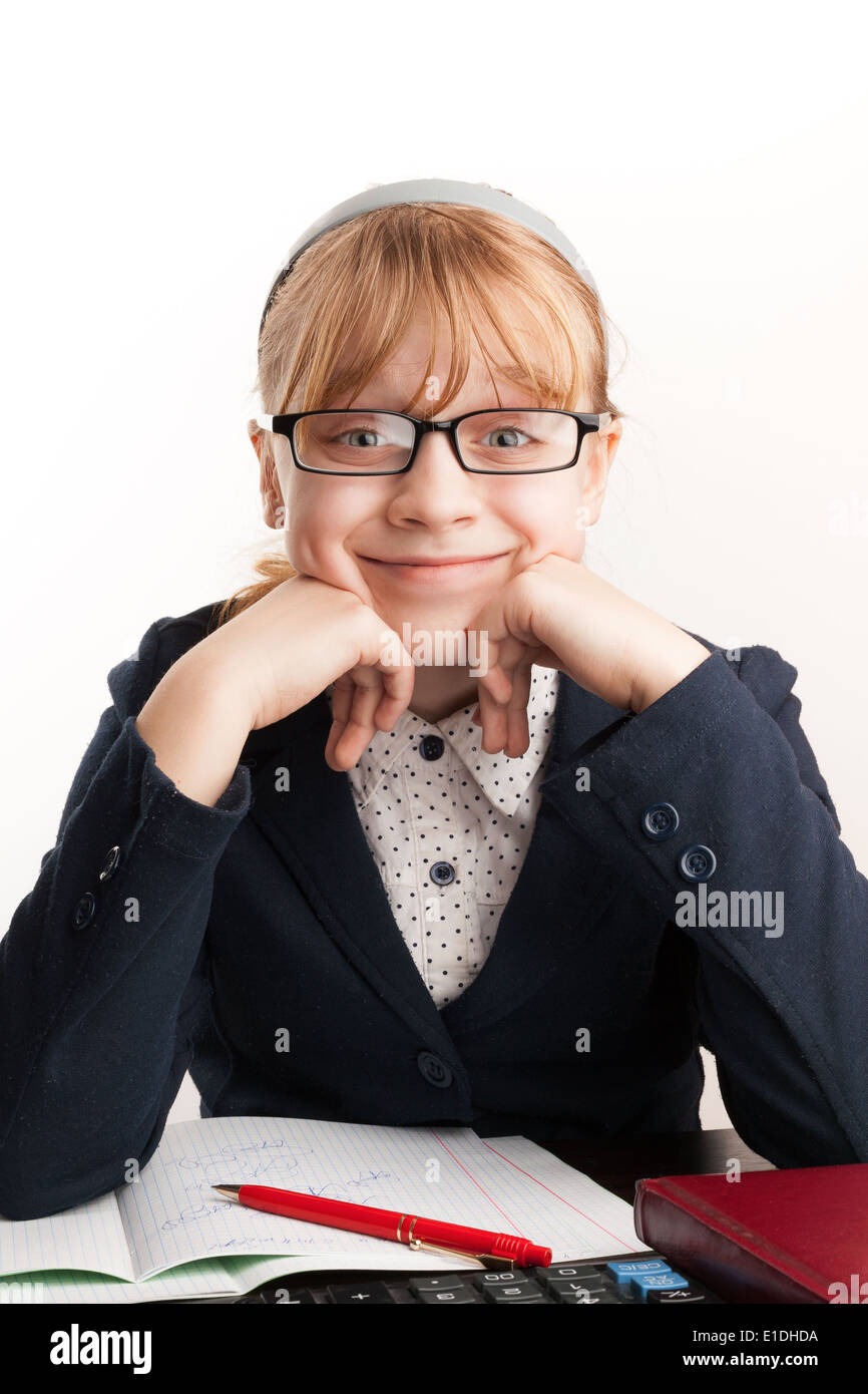 Little blond schoolgirl with glasses smiles above white background Stock Photo