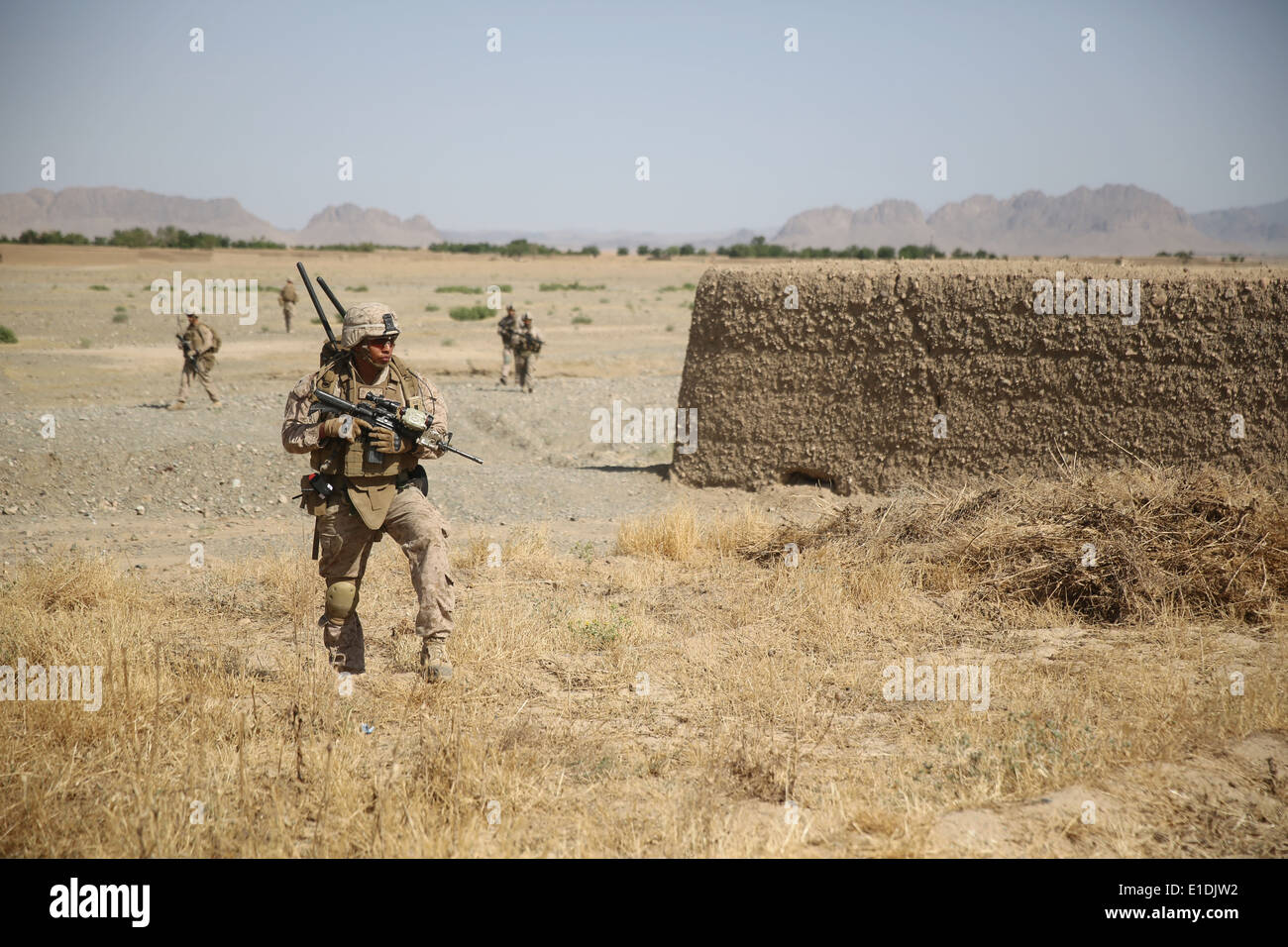 US Marines with the 1st Battalion, 7th Marine Regiment, patrol during a a counter-insurgency mission May 22, 2014 in Larr Village, Helmand province, Afghanistan. Stock Photo