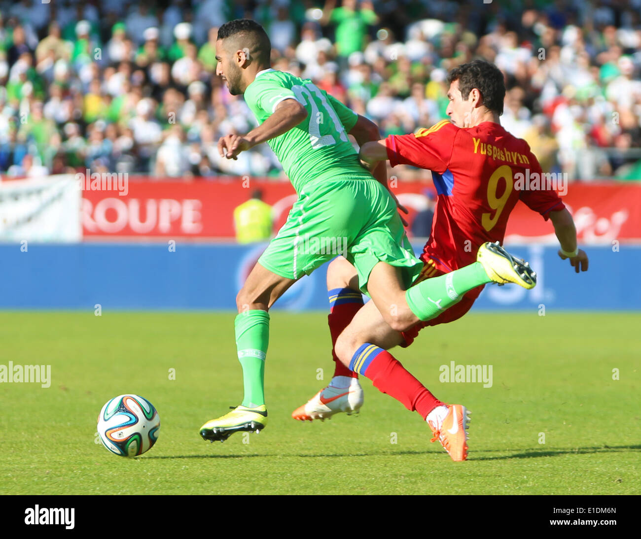 Sion, Switzerland. 31st May, 2014. Artur Yuspashyan is tackled by Riyad Mahrez during the international friendly match between Algeria and Armenia at The Stade de Tourbillon . Credit:  Action Plus Sports/Alamy Live News Stock Photo