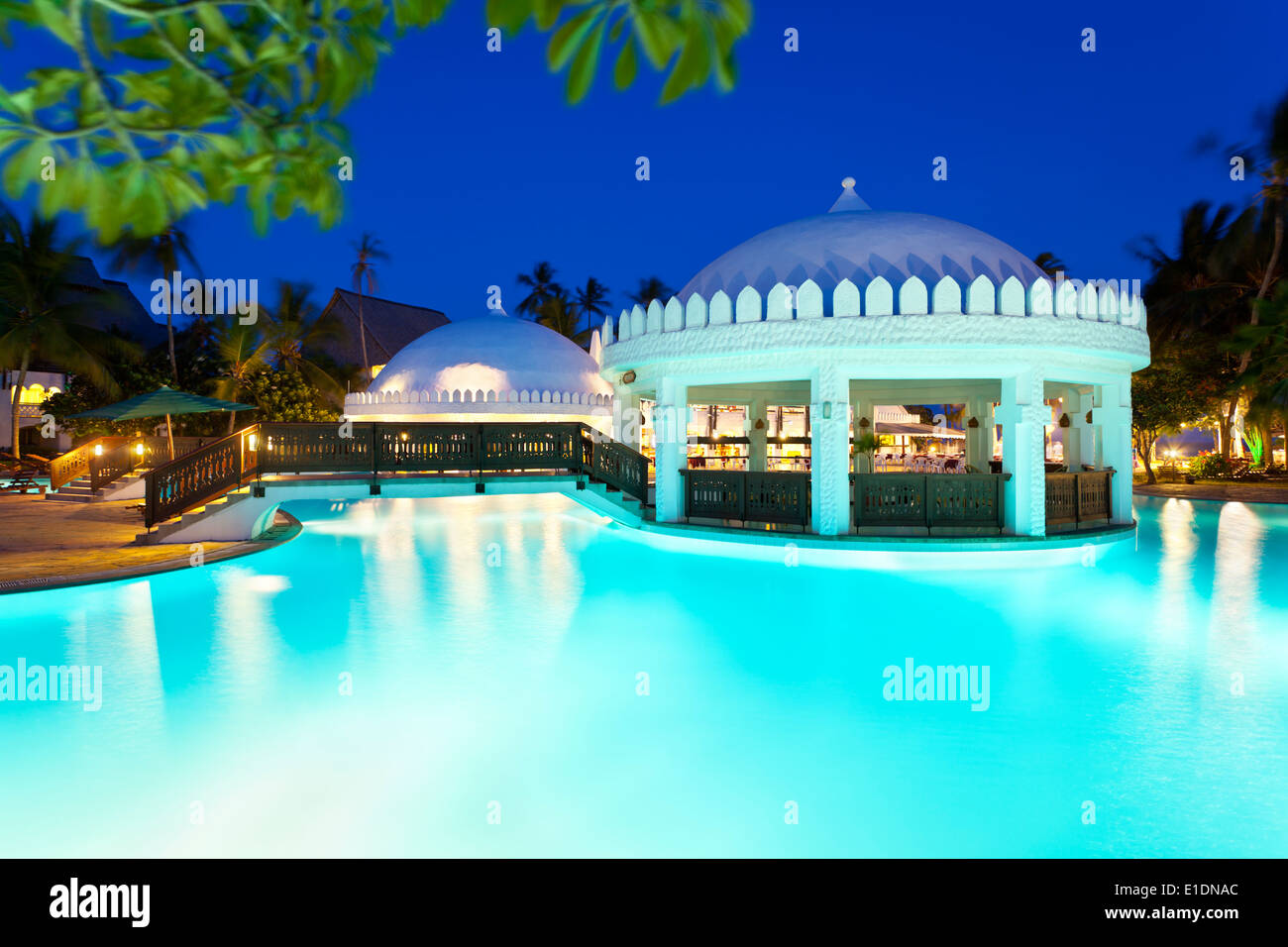 Illuminated pool and bar area at night. Stock Photo