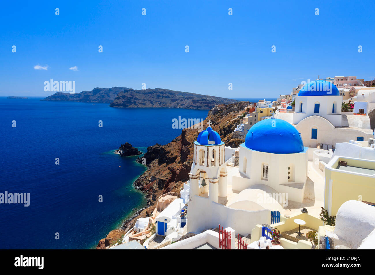 Blue domed churches on the Caldera at Oia on the Greek Island of Santorini. Stock Photo