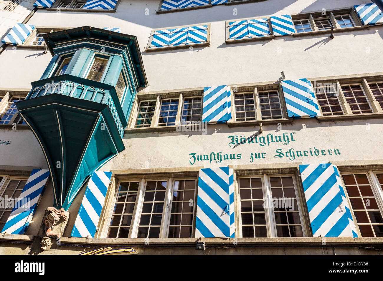 Facade of a typical house with bay window, gothic lettering, window shutters with the colors of the city, Zurich, Switzerland. Stock Photo