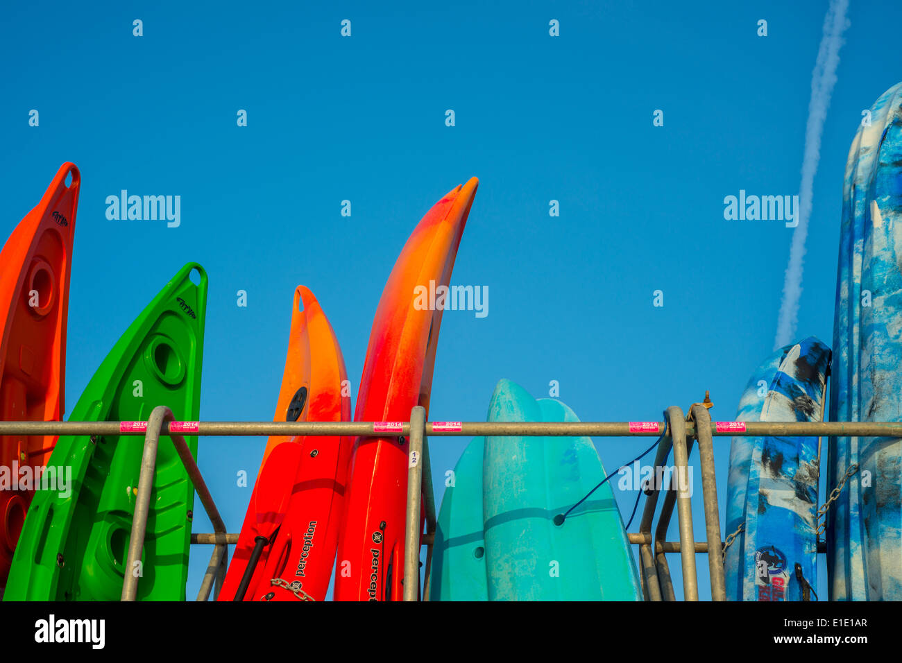 Colourful kayaks by the sea at Lyme Regis, Dorset, England, UK Stock