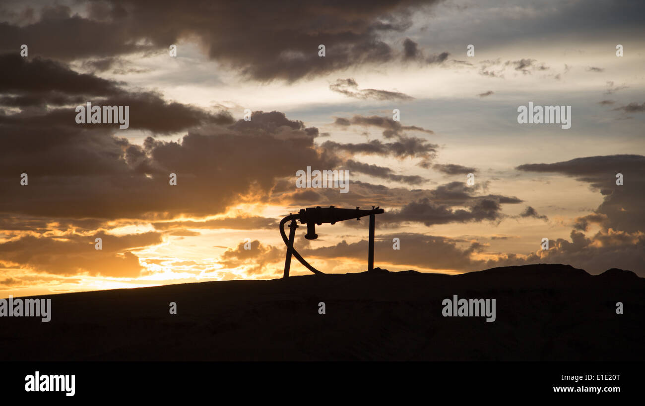 Tailling Cyclone The silhouette of a tailings distribution cyclone against a beautiful ...