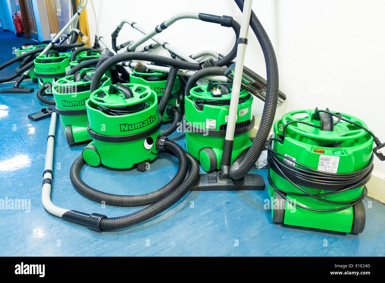 group of Henry Numatic vacuum cleaners in office corridor Stock Photo