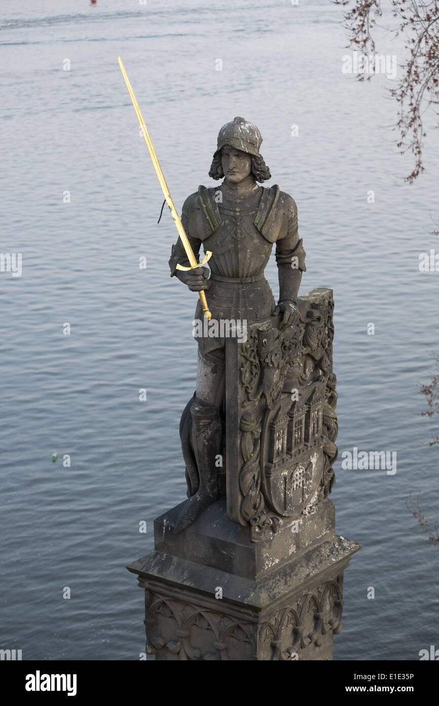 Statue of knight with a golden sword at the Charles bridge in Prague
