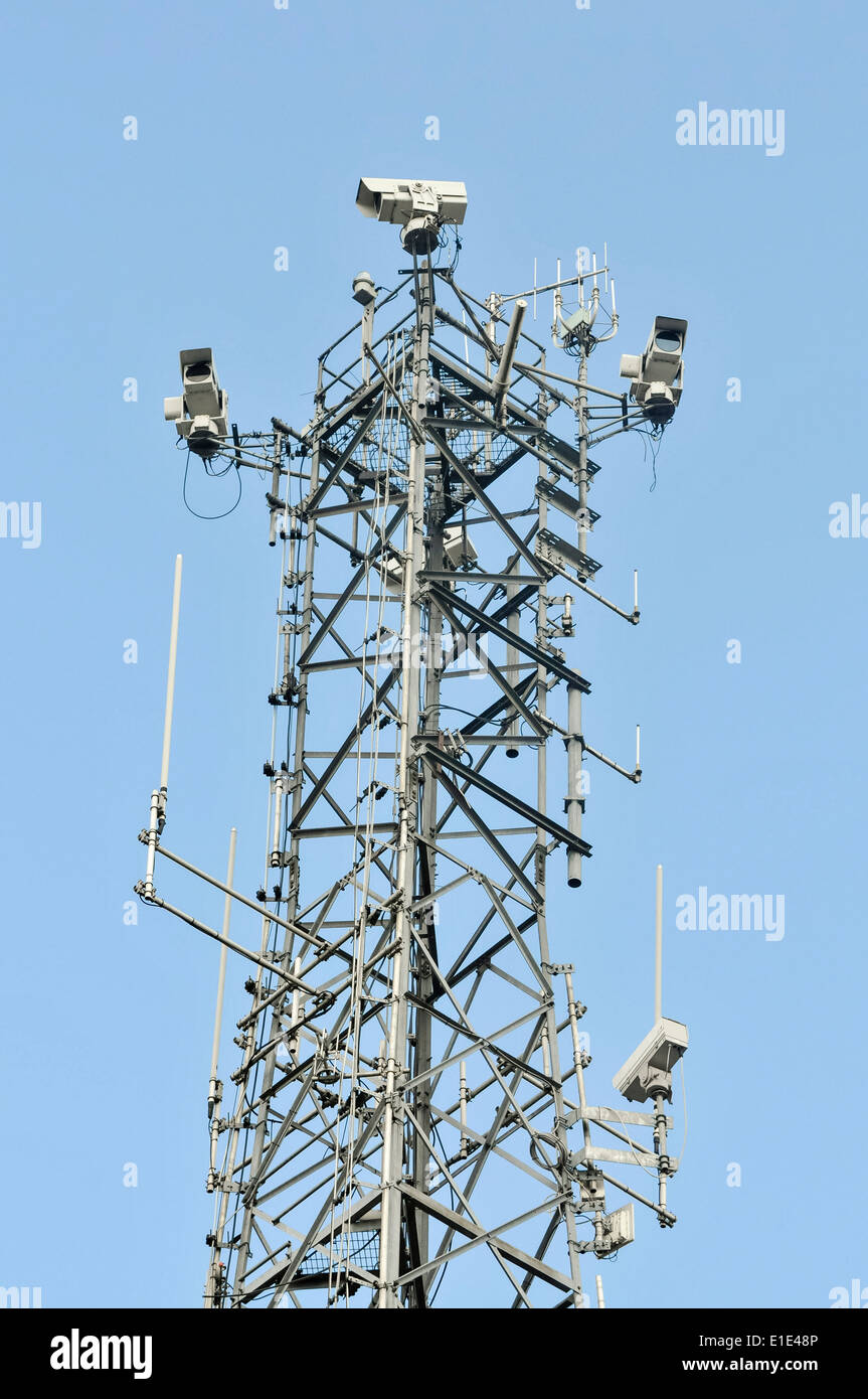 Communications tower cell tower with mobile phone antennae and CCTV cameras Stock Photo